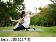 Young female with outdoor activities in the city park, Yoga is her chosen activity. Стоковое фото, агентство Ingram Publishing / Фотобанк Лори