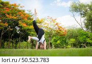 Young female with outdoor activities in the city park, Yoga is her chosen activity. Стоковое фото, агентство Ingram Publishing / Фотобанк Лори