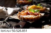 Peach vegan tarts with grated coconut  and crunchy peanuts. Fruit cake. Date, walnut, almond and hazelnut base. Стоковое фото, агентство Ingram Publishing / Фотобанк Лори