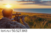 Soldier aiming rifle at sunset by the sea. Стоковое AI-изображение, AI-художник Данила Большаков / Фотобанк Лори