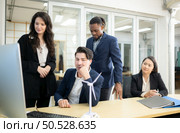 Diverse team of businessmen and engineers consultation on the engineering of a wind turbine that converts wind energy to electricity in the office. Стоковое фото, агентство Ingram Publishing / Фотобанк Лори