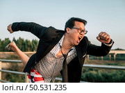 Young funny Asian Businessman wearing shirt and tie with shorts and eyeglasses in crazy and funny manner posture, copy space. Стоковое фото, агентство Ingram Publishing / Фотобанк Лори