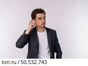 Portrait of thinking man surrounded by question mark on isolated background. Finding inspiration or solution to problem. Стоковое фото, агентство Ingram Publishing / Фотобанк Лори