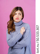 Portrait of beautiful young woman thinking about new idea and looking at something isolated over pink background. People lifestyle concept. Стоковое фото, агентство Ingram Publishing / Фотобанк Лори