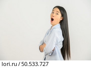 Portrait of Excited young asian woman in blue shirt crossed arm isolated on white background. Expression and lifestyle concept. Стоковое фото, агентство Ingram Publishing / Фотобанк Лори