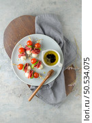 Italian style appetizer, antipasto skewer or caprese on a stick with basil, salami, mozarella and tomatoes. Стоковое фото, агентство Ingram Publishing / Фотобанк Лори