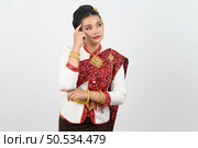 Portrait young pretty woman dress up in beautiful  local culture in northern region with thoughtful posture on white background, copy space. Стоковое фото, агентство Ingram Publishing / Фотобанк Лори
