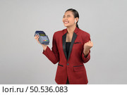 Portrait Asian young woman in officer uniform feel excited  to showing credit card and payment machine, copy space for insert advertising your product, isolated on white background. Стоковое фото, агентство Ingram Publishing / Фотобанк Лори