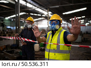Restricted area, officials employ white and red stripes to block the area where a chemical leak is occurring. To prevent individuals from coming into contact with potentially dangerous chemicals, Стоковое фото, агентство Ingram Publishing / Фотобанк Лори