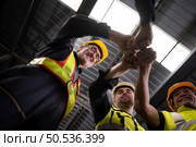 Engineers and technicians must join forces when they want to accomplish big tasks. Uniting together to help each other make great things happen. Стоковое фото, агентство Ingram Publishing / Фотобанк Лори