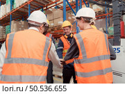 The manager encouraged the warehouse workers to work hard to get the goods out of the warehouse to finish the small merchants tonight. By joining hands and creating a boom. Стоковое фото, агентство Ingram Publishing / Фотобанк Лори