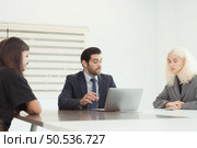 In the company meeting room Young executives are brainstorming ideas about a new business that will launch big soon. Стоковое фото, агентство Ingram Publishing / Фотобанк Лори