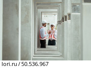 Two young entrepreneurs who own a pottery business. generate enough income from the business to expand the business to accommodate the increasing number of customers. Стоковое фото, агентство Ingram Publishing / Фотобанк Лори