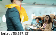Flight attendants show how to use safety devices and recommend emergency exits. Стоковое фото, агентство Ingram Publishing / Фотобанк Лори