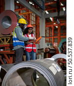 Two technicians Inspecting and testing the operation of lifting cranes in heavy industrial plants. Стоковое фото, агентство Ingram Publishing / Фотобанк Лори