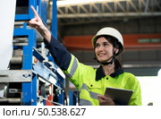 Portrait of a heavy equipment female engineer from a huge industry who came to inspect the factory’s machinery. Стоковое фото, агентство Ingram Publishing / Фотобанк Лори