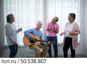 Old people’s companions To unwind during the weekend, gather together for activities like singing, playing the guitar, and chit-chatting. Стоковое фото, агентство Ingram Publishing / Фотобанк Лори