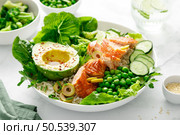 Salmon avocado bowl with broccoli, green peas, rice and fresh salad. Healthy food, top view. Стоковое фото, агентство Ingram Publishing / Фотобанк Лори