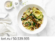 Couscous with avocado, spinach and sauteed champignon mushrooms with onion, top down view. Стоковое фото, агентство Ingram Publishing / Фотобанк Лори