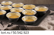 Egg tarts, traditional portuguese dessert, pastel de nata, custard tarts during home production on metal tray. Стоковое фото, агентство Ingram Publishing / Фотобанк Лори