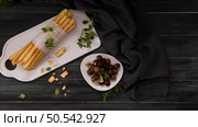 Fresh baked homemade grissini bread sticks in white ceramic tray with olive oil and basil herbs over kitchen counter top. Стоковое фото, агентство Ingram Publishing / Фотобанк Лори