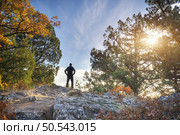 Man strive hands on the mountain edge. Nature and people scene. Стоковое фото, агентство Ingram Publishing / Фотобанк Лори