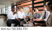 Group of diverse business people working together in the office, Brainstorming about the hand robot model to be used for production work. Стоковое фото, агентство Ingram Publishing / Фотобанк Лори