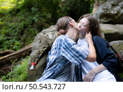 Young couple hiking in the forest with backpacks and trekking poles. Стоковое фото, агентство Ingram Publishing / Фотобанк Лори