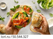 Salmon sandwiches with cream cheese, fresh romaine lettuce and cucumber, top down view. Стоковое фото, агентство Ingram Publishing / Фотобанк Лори