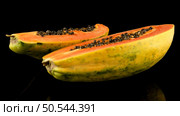 Fresh and tasty papaya on black background. Стоковое фото, агентство Ingram Publishing / Фотобанк Лори