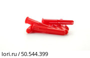 Red plastic dowels isolated on white background. Стоковое фото, агентство Ingram Publishing / Фотобанк Лори