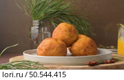 Traditional portuguese Christmas sweets Sonhos with sugar and cinnamon on kitchen countertop. Стоковое фото, агентство Ingram Publishing / Фотобанк Лори