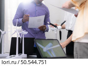 Group of multi-national team of architects and designers is meeting to brainstorm designs for wind turbines to capture wind energy and convert it into electrical energy. Стоковое фото, агентство Ingram Publishing / Фотобанк Лори