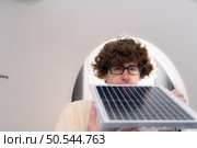 A young male architect and designer is designing a green home building that takes advantage of natural energy such as wind and sunlight. Стоковое фото, агентство Ingram Publishing / Фотобанк Лори