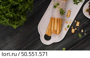 Fresh baked homemade grissini bread sticks in white ceramic tray with olive oil and basil herbs over kitchen counter top. Стоковое фото, агентство Ingram Publishing / Фотобанк Лори