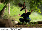 Villagers in rural Thailand are raising fighting cocks to compete in cockfighting, a native sport. Стоковое фото, агентство Ingram Publishing / Фотобанк Лори