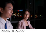 Group of broker international stock traders wearing headset working actively at night in office, Concept of customer support agent provide service on telephone. Стоковое фото, агентство Ingram Publishing / Фотобанк Лори