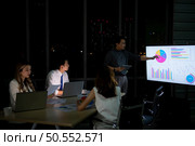 Group of broker international stock traders working actively at night in office, Everyone is striving for the team’s success. Стоковое фото, агентство Ingram Publishing / Фотобанк Лори