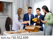 Group of owner small business Clothes are being packaged for delivery to customers in cardboard boxes and cushioned lump from natural materials that are not toxic to the planet. Стоковое фото, агентство Ingram Publishing / Фотобанк Лори