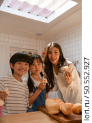 Family happy moments when children Helping mom cook food in the kitchen. Стоковое фото, агентство Ingram Publishing / Фотобанк Лори
