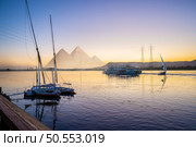 Nile River and boats at sunset in Luxor and pyramids. Nile River and boats and pyramids. Стоковое фото, агентство Ingram Publishing / Фотобанк Лори