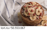 Healthy breakfast table,  homemade pancakes with banana, goji and walnuts. Стоковое фото, агентство Ingram Publishing / Фотобанк Лори