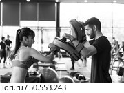 Young couples work out at the gym to strengthen the body. Each person recommends exercise for each other and encourage each other while exercising. Стоковое фото, агентство Ingram Publishing / Фотобанк Лори