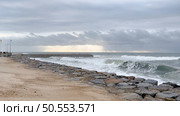 OVAR, PORTUGAL - 31 OCTOBER 2023: The sea rises to the seafront of Furadouro in Ovar. The advance of the sea due to climate change threatens Portugal. Стоковое фото, агентство Ingram Publishing / Фотобанк Лори