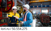 Engineer and technician discussing machinery in factory to plan inspection maintenance according to usage cycle, Concepts inspections based on usage cycle maintenance. Стоковое фото, агентство Ingram Publishing / Фотобанк Лори