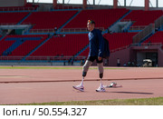 Disabled athletes prepare their bodies on amphitheater in a sports arena on a sunny day before entering a short-distance running competition. Стоковое фото, агентство Ingram Publishing / Фотобанк Лори