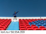 Athletes with disabilities cheer from the stands in a sports arena. Стоковое фото, агентство Ingram Publishing / Фотобанк Лори