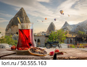 View of Cappadocia and a cup of Turkish tea. Turkish tea and Cappadocia. Стоковое фото, агентство Ingram Publishing / Фотобанк Лори