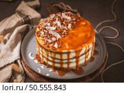 Delicious caramel cake with small pieces of pecan nuts and coconut shavings. Стоковое фото, агентство Ingram Publishing / Фотобанк Лори