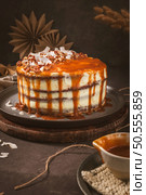 Delicious caramel cake with small pieces of pecan nuts and coconut shavings. Стоковое фото, агентство Ingram Publishing / Фотобанк Лори